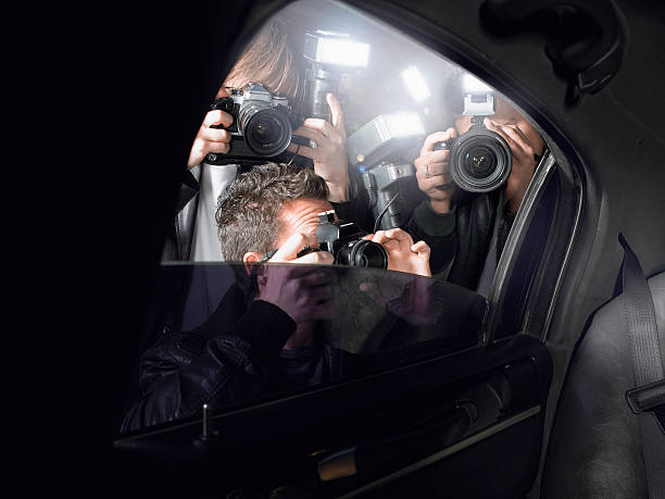 Paparazzi+taking+pictures+through+car+window